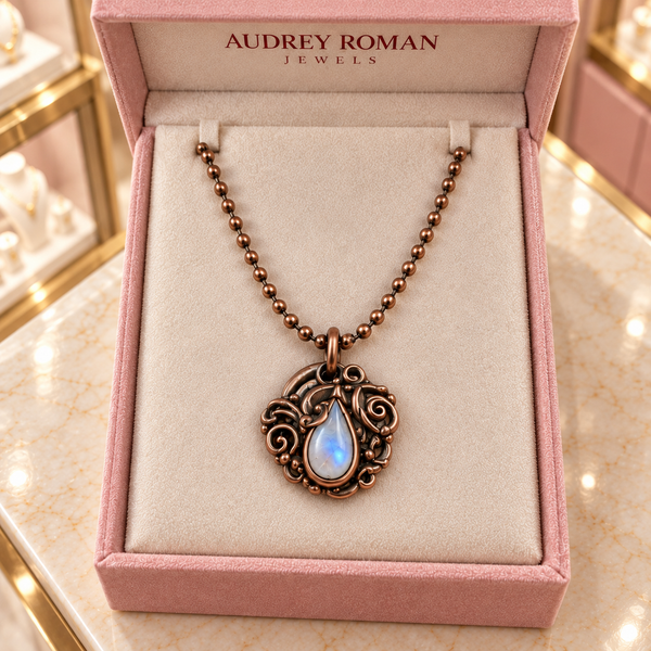 Overhead view of the Clara Necklace in copper tone in an Audrey Roman Jewels box on the boutique counter.