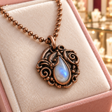 Close-up of the Clara Necklace in copper tone on the ivory insert of an Audrey Roman Jewels box.