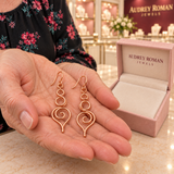 Eleanor Swirl Earrings held in a close detail view inside the boutique.