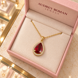 Julia Red Teardrop Pendant Necklace (gold-tone) viewed from above inside the Audrey boutique.