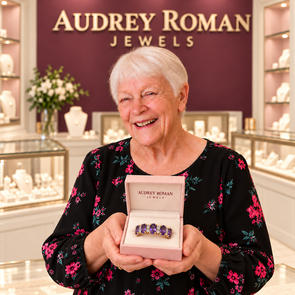 Hazel Purple Crest Ring (rose-gold-tone) presented in its box by the woman in the Audrey boutique.
