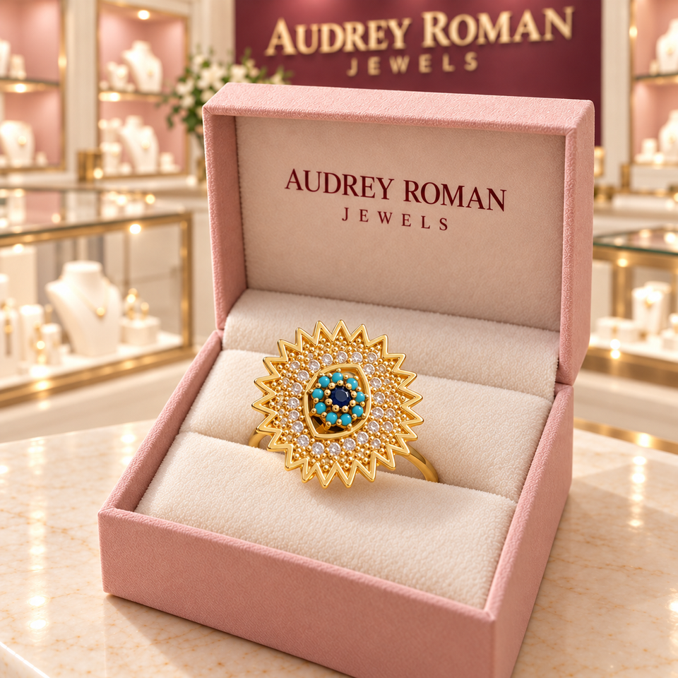 Victoria Blue Sunburst Spinner Ring | Gold-Tone in its Audrey presentation box.