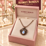 Clara Necklace in copper tone inside a rose Audrey Roman Jewels presentation box on the boutique counter.