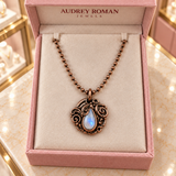 Overhead view of the Clara Necklace in copper tone in an Audrey Roman Jewels box on the boutique counter.
