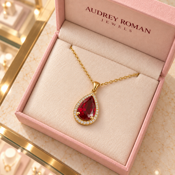 Julia Red Teardrop Pendant Necklace (gold-tone) viewed from above inside the Audrey boutique.