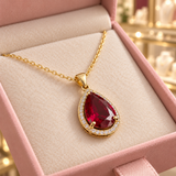 Julia Red Teardrop Pendant Necklace (gold-tone) in a close detail view inside the Audrey boutique.