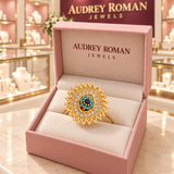 Victoria Blue Sunburst Spinner Ring | Gold-Tone in its Audrey presentation box.